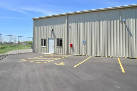 SYT Storage clubhouse, a steel building with a front door and accessible parking