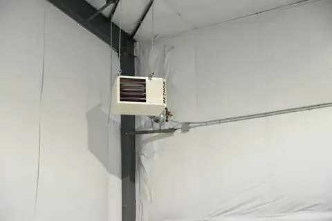 Ceiling-mounted gas heater inside a white-lined SYT Storage unit